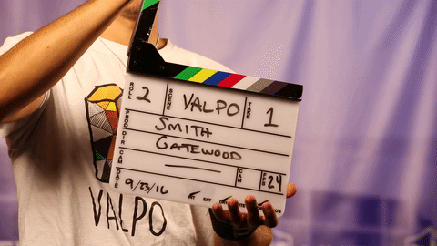 person showing a modern clapper board with the words smith gatewood written on it