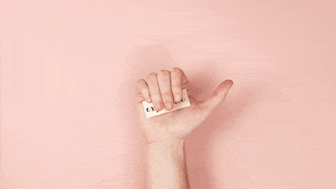 human hand holding the word experience on a piece of white paper and other words appear next to the hand against a pink background