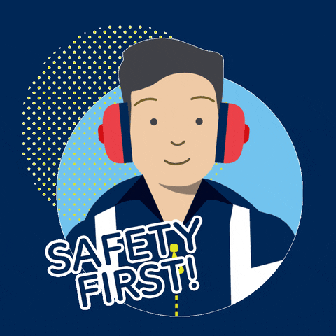 a man wearing ear protection lifts his hand to put a saftey hat on and he winks with the text saying "safety first!"